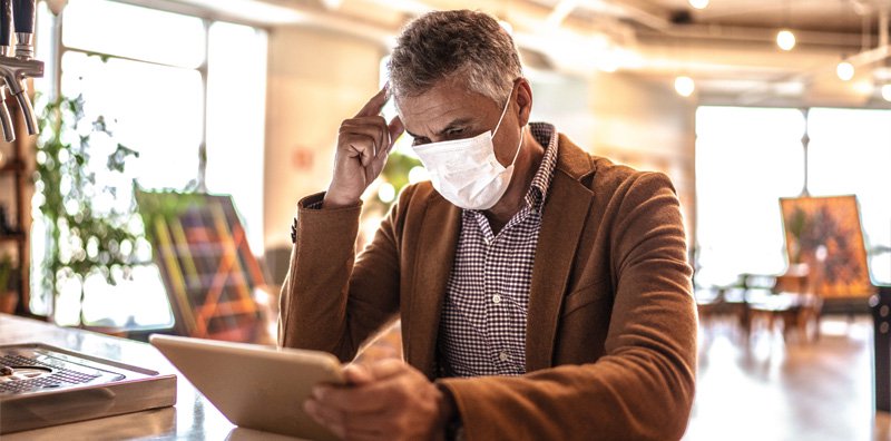Man with COVID mask in office https://gooddayswork.ag/